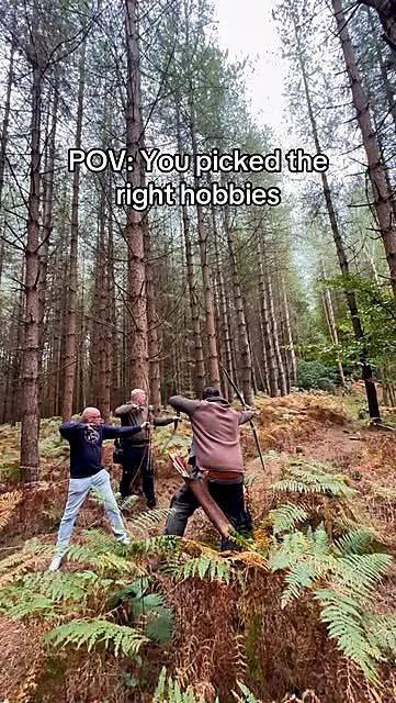 Three traditional archers shooting together on a woodland field archery course