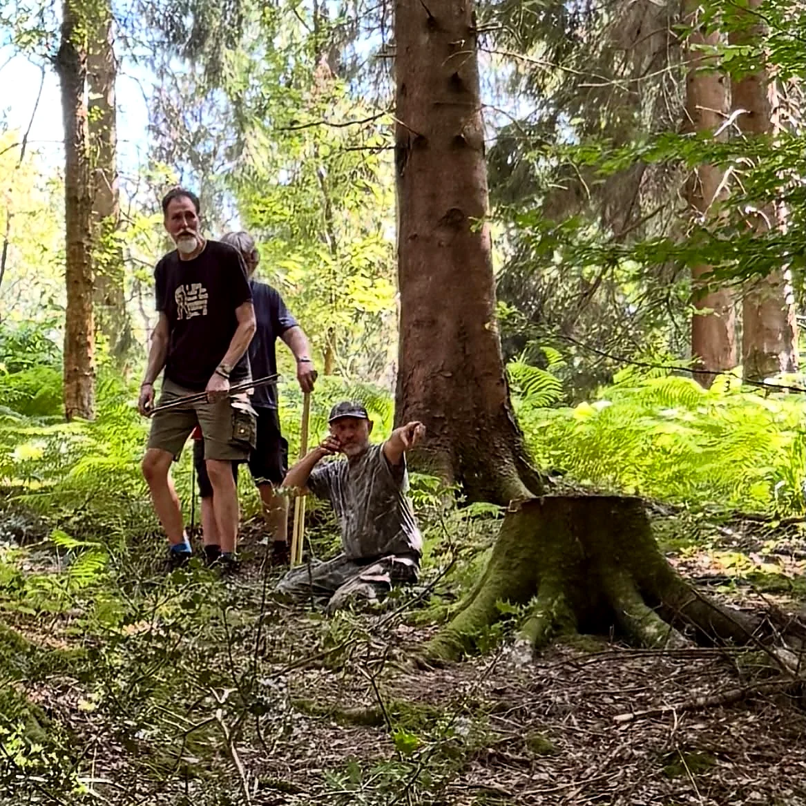 Two Wildwood Rangers team members preparing a woodland field archery course