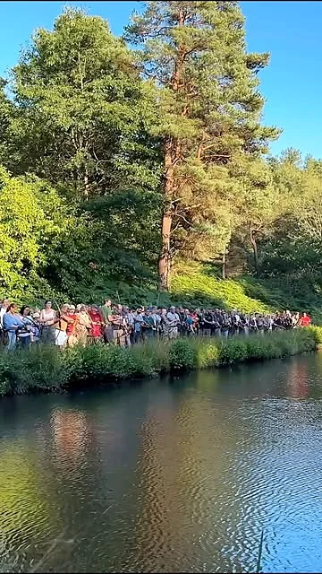 Group gathered beside a lake during a Bodnik Bowhunter Challenge UK activity
